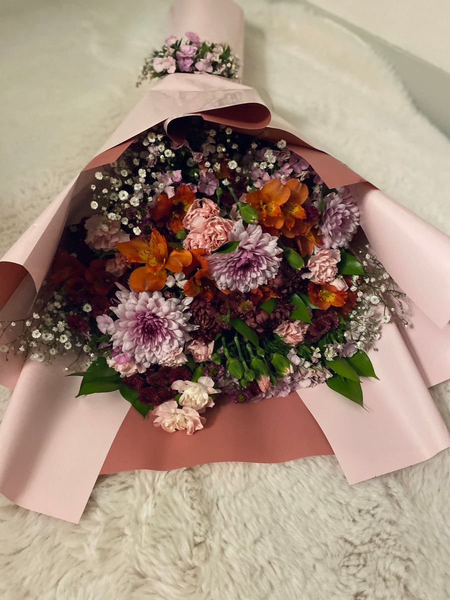 Mixed flowers in soft pink wrapping