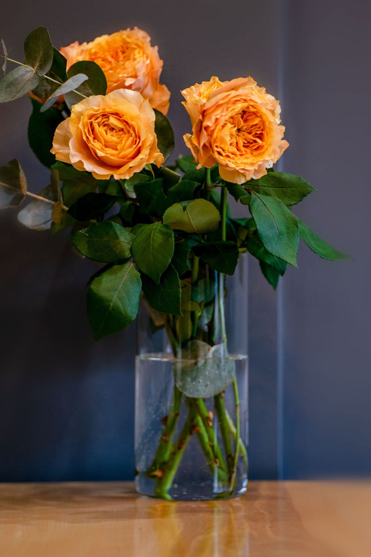 A simple rose arrangement in a clear vase at home