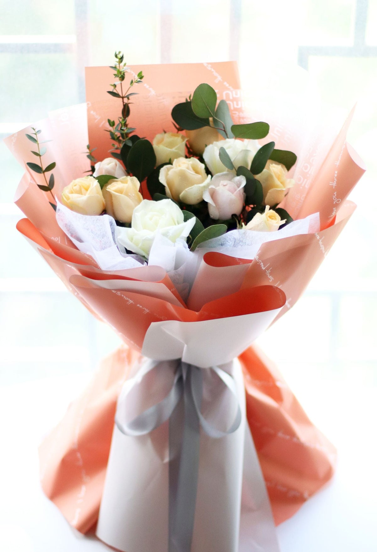 Cream roses in soft pink bouquet wrapping