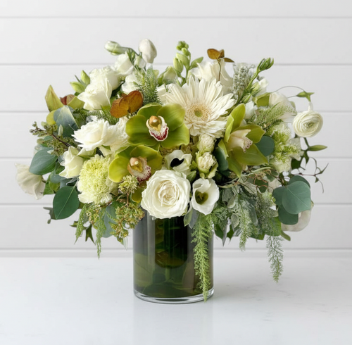 Reference: clear cylinder glass vase with flowers, flowers not included.
