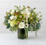 White and green seasonal flower arrangement in glass cylinder vase; illustrative floral mix and vase specification.