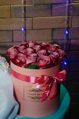 Pink roses arranged in a gift box, illustrative presentation.