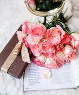 Pink and ivory roses styled against a white background; palette reference, not the final Luma mixed-rose bouquet. Photo: Melike B / Pexels.