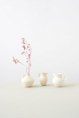 Sculptural ceramic vase forms against a white background; shape category illustration only, not the actual Midnight U planter or its colour. Photo: DS stories / Pexels.